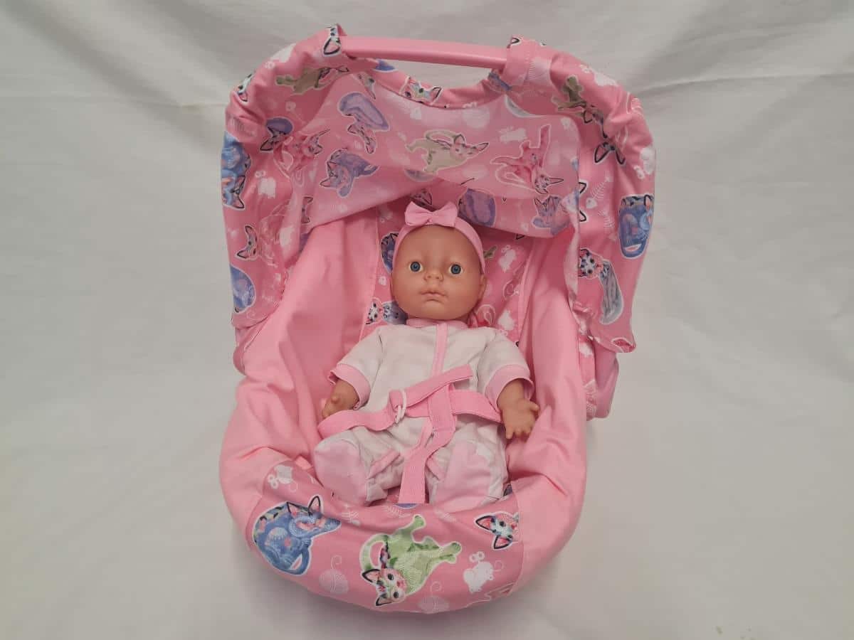Doll and Pink Carry Cot